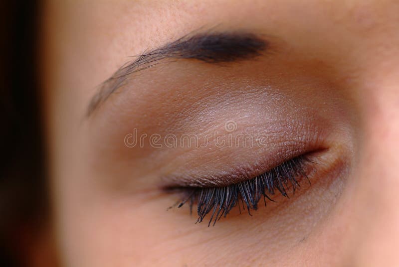 Closed eye with mascara and picked eyebrow