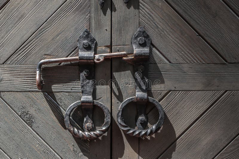 Closed large old door with round handles. Fragment. stock image Closed large old door with round handles. Fragment. stock image