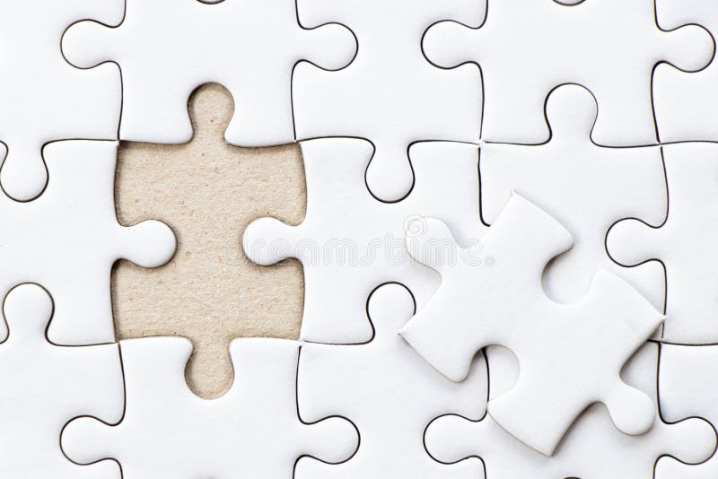 Closed up background of white plain jigsaw wait missing piece to match or fulfill