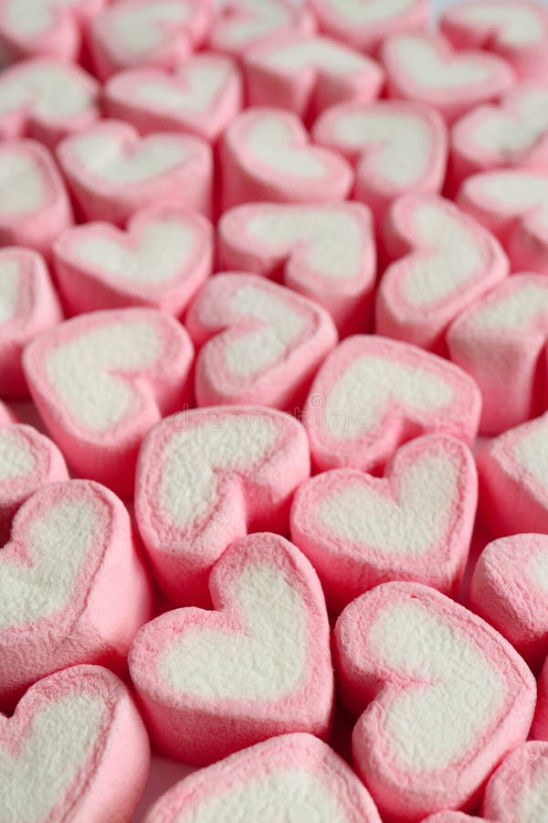 Pink heart shaped marshmallows background Stock Photo