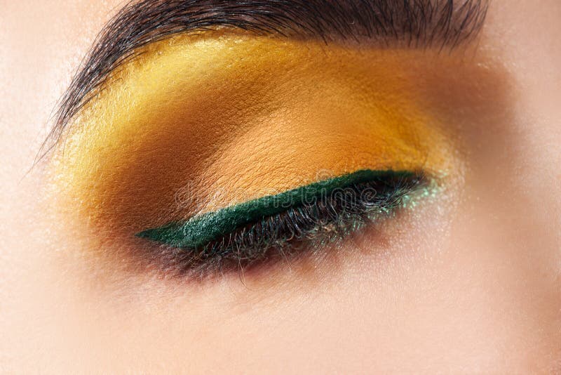 Closed Woman Eye with Yellow Makeup and Green Stripe Stock Image