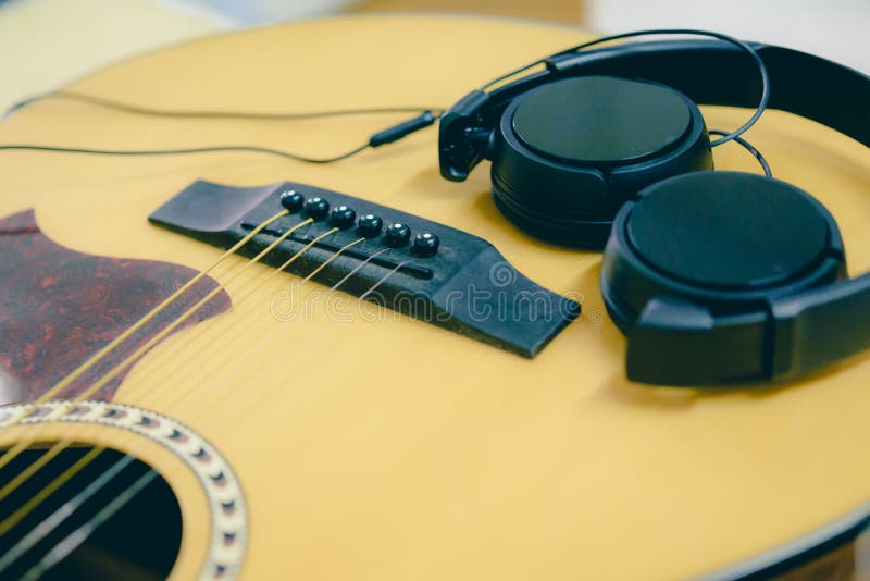 Closeup acoustic guitar and headphone. royalty free stock photo Closeup acoustic guitar and headphone. royalty free stock photo