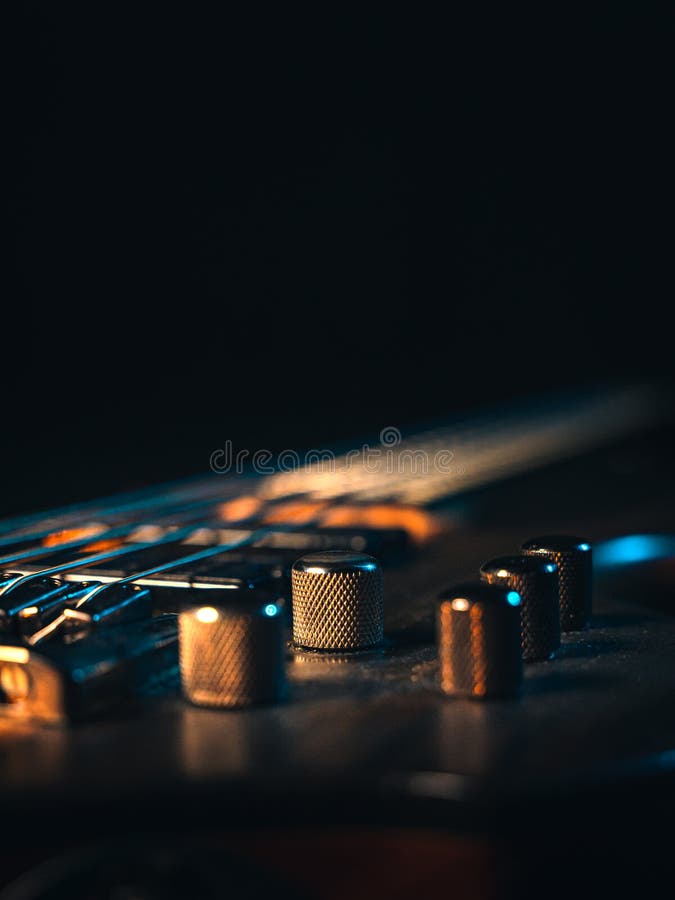 Closeup of Adjustment Knobs of an 5 Stringed Electric Bass Guitar Stock