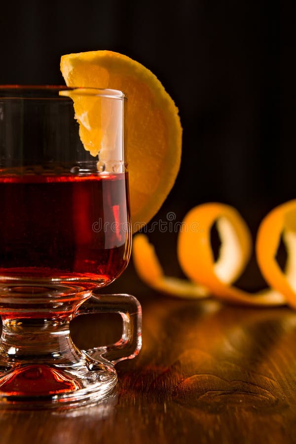 Closeup of Alcoholic Punch Drink and Orange Peel on Background Stock