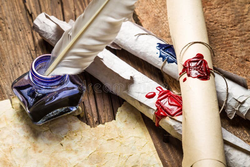 Closeup of ancient scrolls written with ink and feather bird royalty free stock images