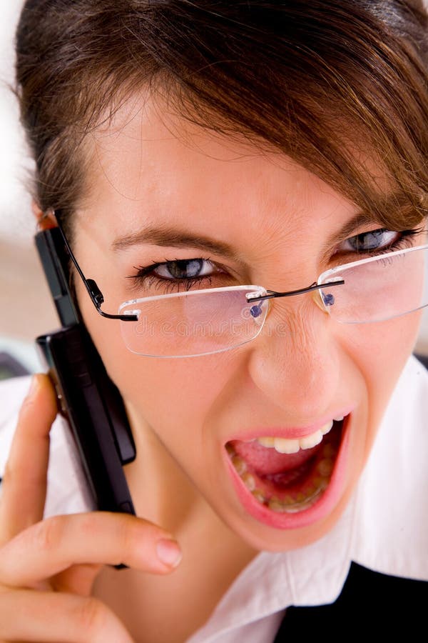 Closeup of angry young female lawyer on the phone