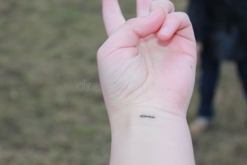 Closeup of the Arm with an Infinity Symbol Tattooed in His Wrist. Infinity  Sign on the Hand. Endless Love Concept Stock Photo - Image of brotherhood,  shape: 180485864