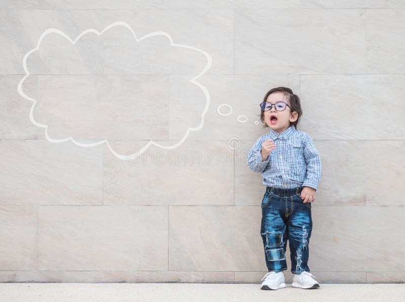 Closeup asian kid say something action with text box on marble stone wall textured background with copy space