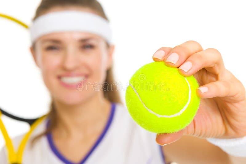 Closeup on tennis ball in hand of female tennis player