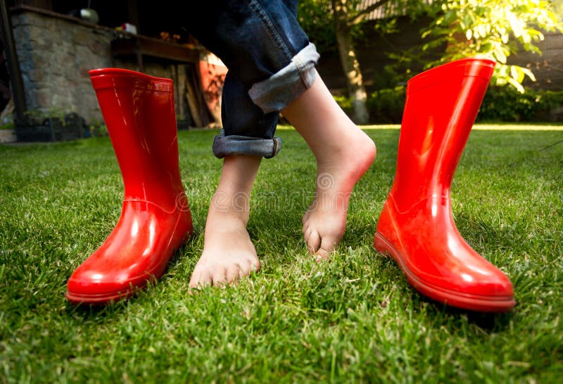 Closeup of Barefoot Girl Standing on Grass with Red Rubber Boots Stock ...
