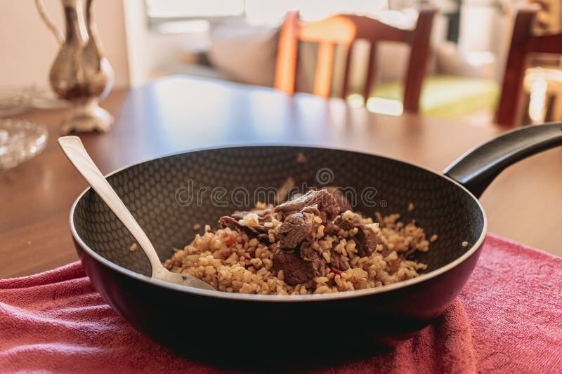 Closeup of Beef Fried Rice Served in Black Iron Pan. Stock Image