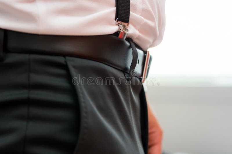 Closeup of belt with suspenders.