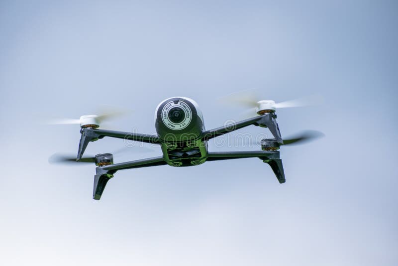 Drone in Flying with Visible Movement in Blue Sky Stock Photo Image
