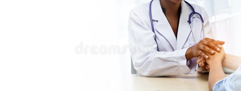 Closeup Black female doctor holding hands patient with love, care, helping, encourage and empathy at hospital