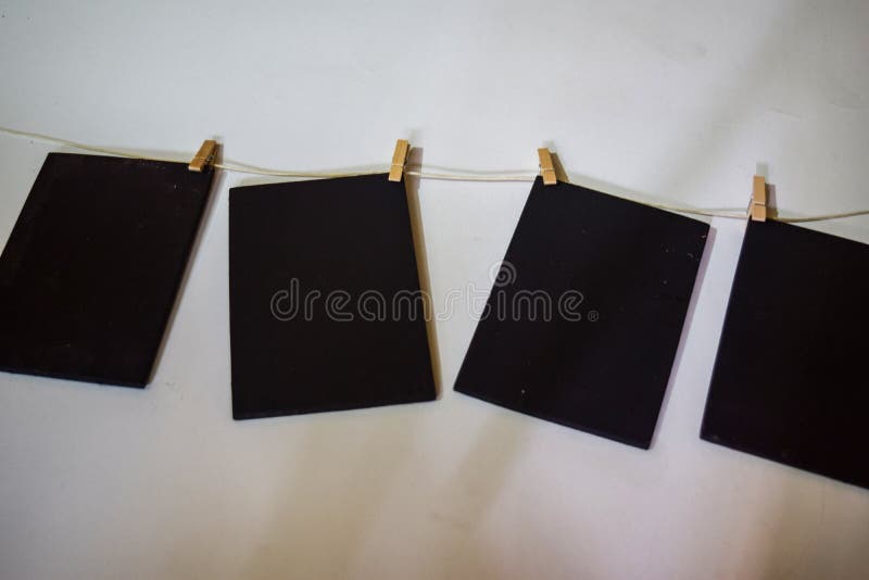 Closeup black paper attach to rope with clothes pins on white background royalty free stock photo Closeup black paper attach to rope with clothes pins on white background royalty free stock photo