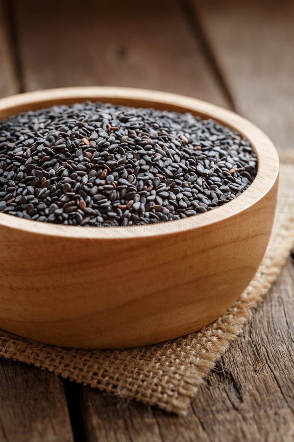 Closeup black sesame in bowl organic grains herb