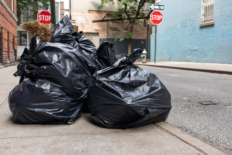 https://thumbs.dreamstime.com/b/closeup-black-trash-bags-along-empty-street-sidewalk-greenwich-village-new-york-city-black-trash-bags-along-260761754.jpg