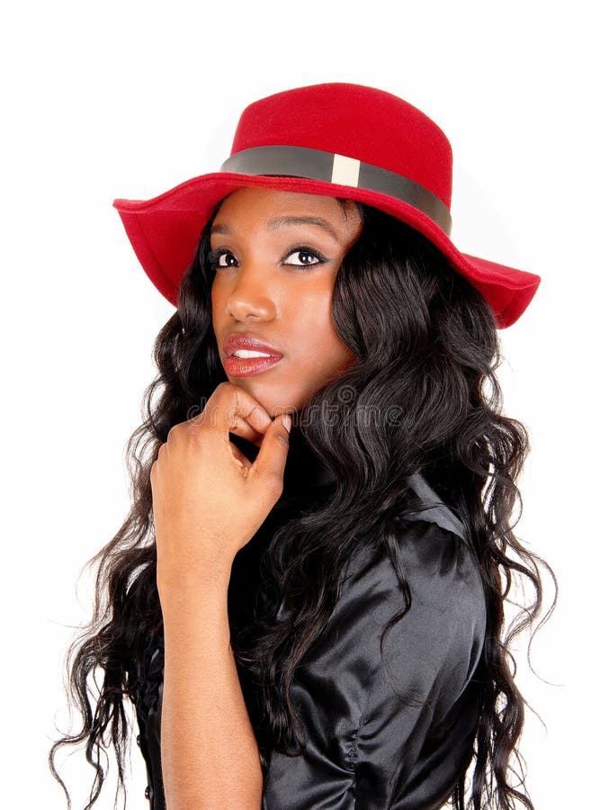 Closeup of black woman with red hat.