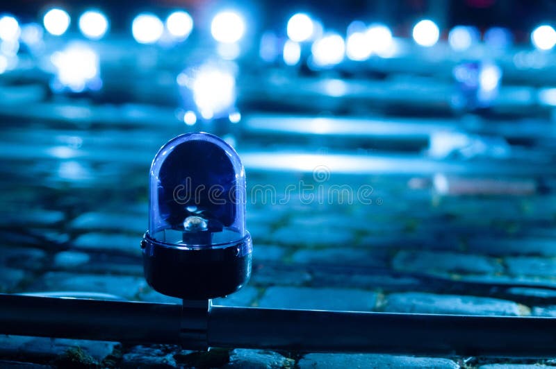 Closeup of a Blue Flashing Siren on the Street at Night Stock Image