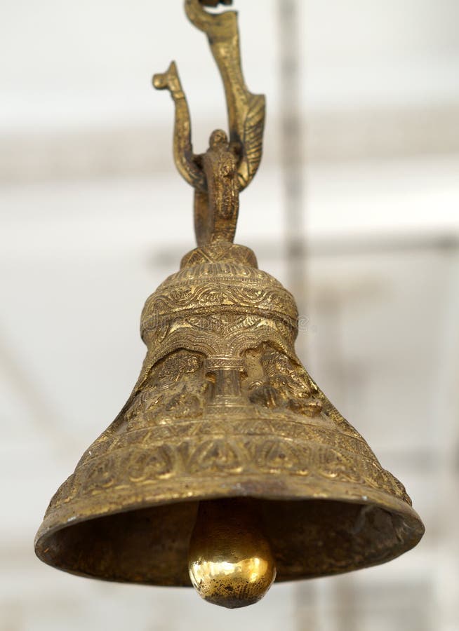 Closeup of Brass bell hung in front of deity in Hindu temple