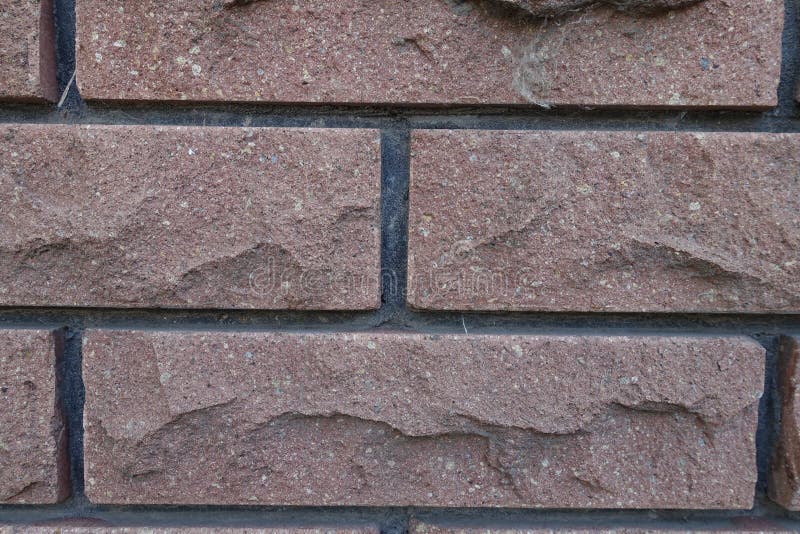 Closeup of Brown Brick Veneer Wall with Black Mortar Joints Stock Photo