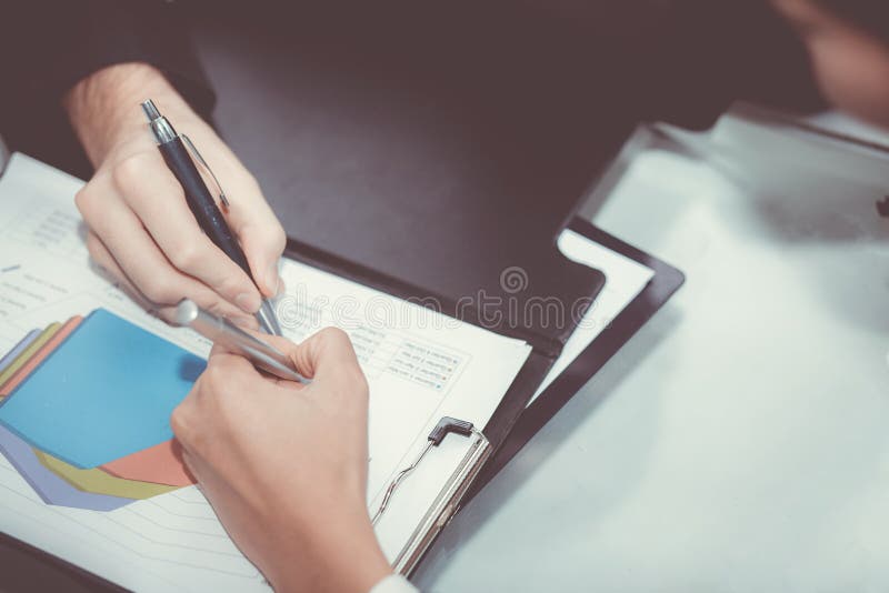 Closeup of business partners hands over document with charts and graph. royalty free stock photography Closeup of business partners hands over document with charts and graph. royalty free stock photography