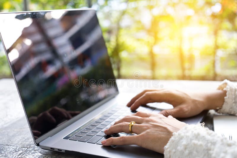 Closeup business woman hands typing on laptop keyboard on desk. royalty free stock photography