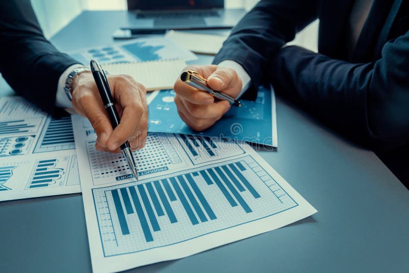 Closeup busy analyst team discussing financial data on laptop. Fervent royalty free stock photo