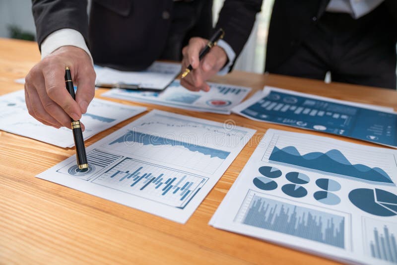 Closeup busy analyst team discussing financial data on laptop. Fervent stock photography