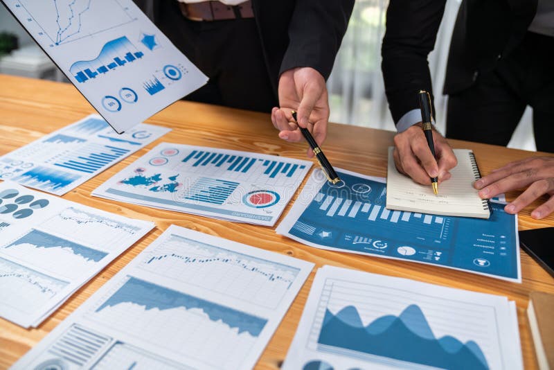 Closeup busy analyst team discussing financial data on laptop. Fervent royalty free stock photography