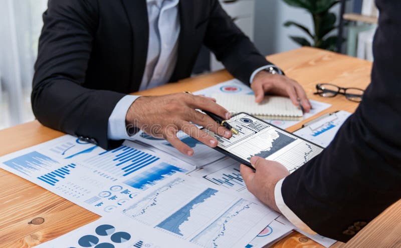 Closeup busy analyst team discussing financial data on laptop. Fervent stock photography
