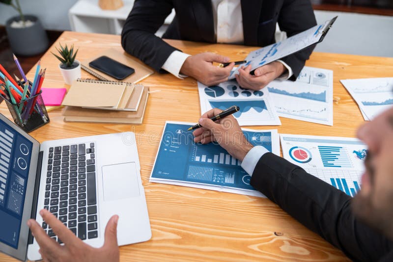 Closeup busy analyst team discussing financial data on laptop. Fervent royalty free stock photo