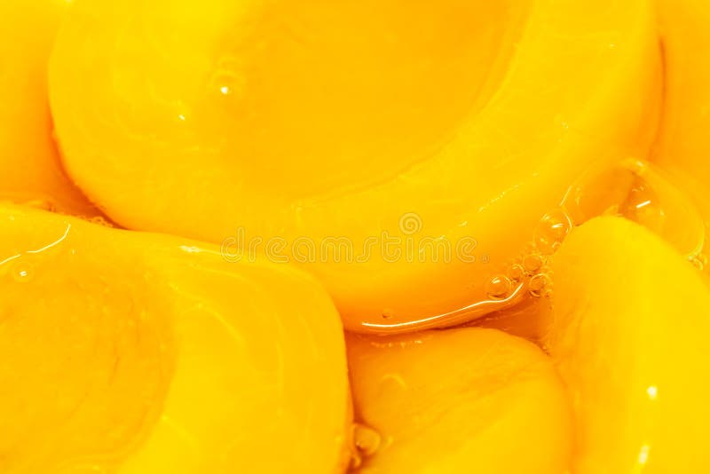 Closeup canned peach halves in syrup stock photography