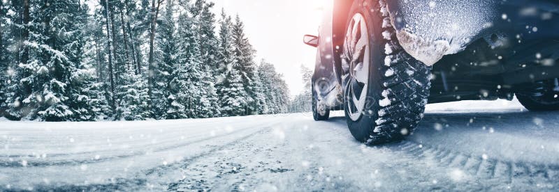 Closeup of car tires in winter on the road