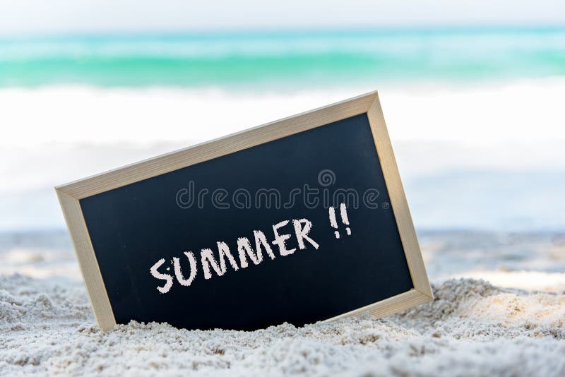 Closeup of a chalkboard with the text summer written on the sand of a beach. royalty free stock photo Closeup of a chalkboard with the text summer written on the sand of a beach. royalty free stock photo