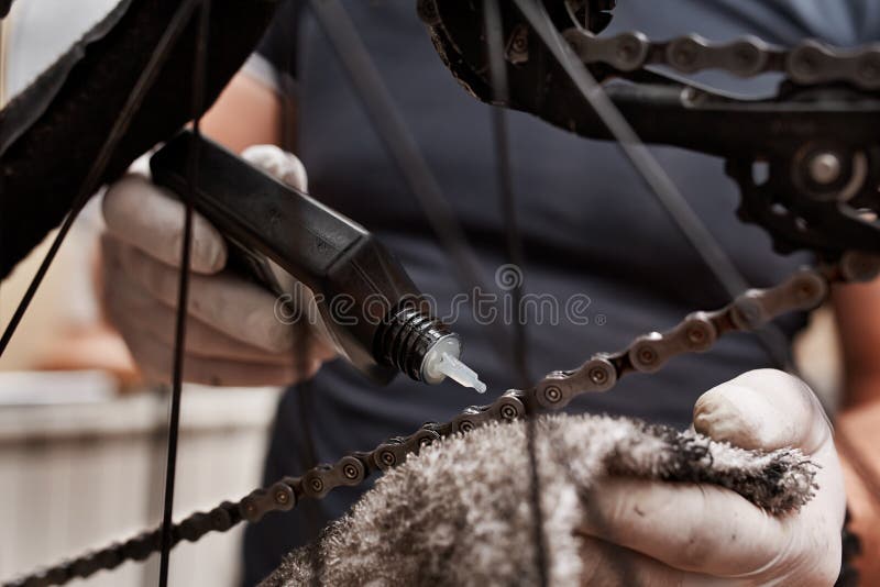 Cleaning and Oiling a Bicycle Chain and Gear with Oil Stock Photo