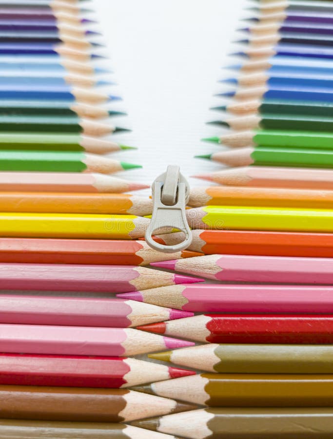 Closeup of Colored Pencils Lined Up in a Row and Abstract Shape on