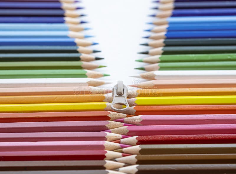 Closeup of Colored Pencils Lined Up in a Row and Abstract Shape on