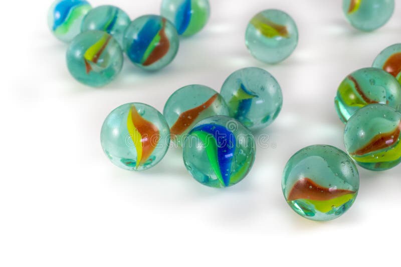 Closeup of Colorful Glass Marble Balls Under the Lights on a White