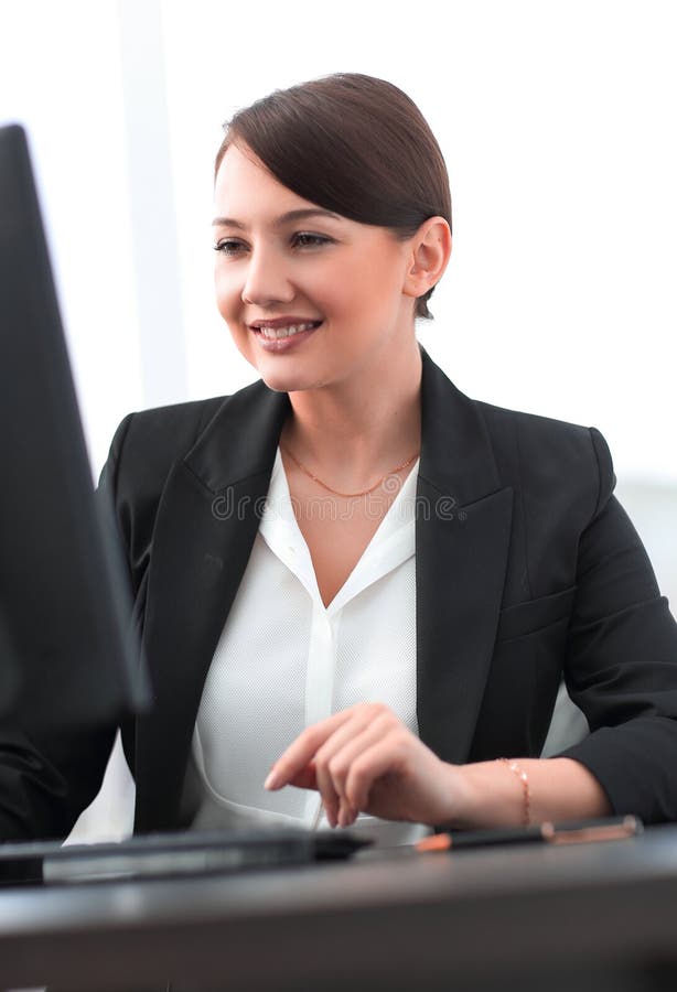 Closeup of a confident young business woman working on computer