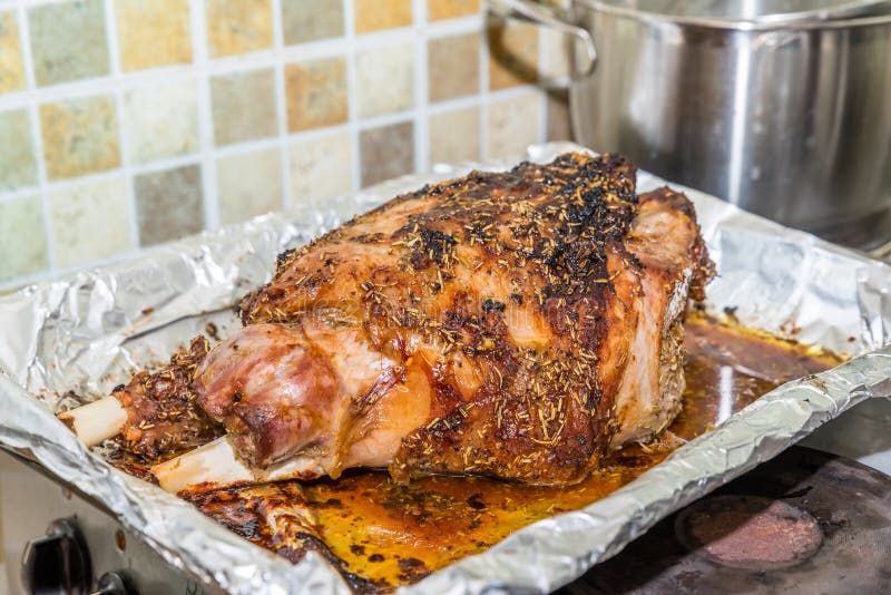 Closeup Cooked Lamb Leg Joint on Roasting Tin Foil Ready for Serving