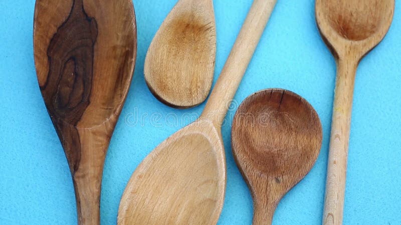Closeup of cooking spoons on blue rotating table stock footage