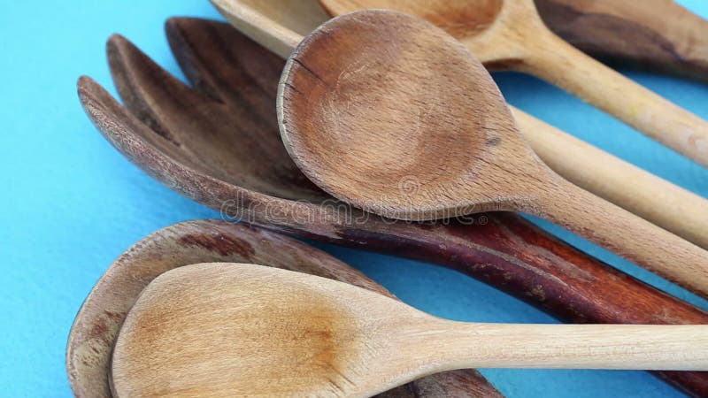 Closeup of cooking spoons on blue rotating table stock footage