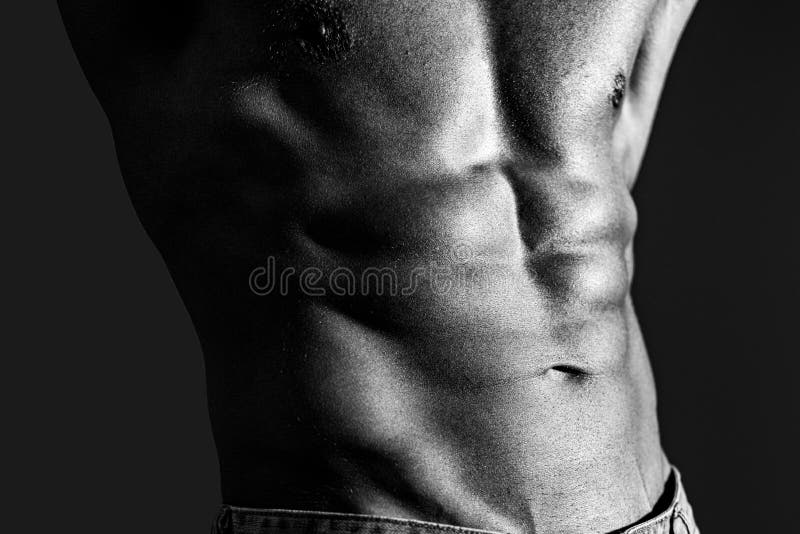 Closeup of cool perfect sexy strong sensual bare torso with abs pectorals and 6 pack muscles and muscular chest black