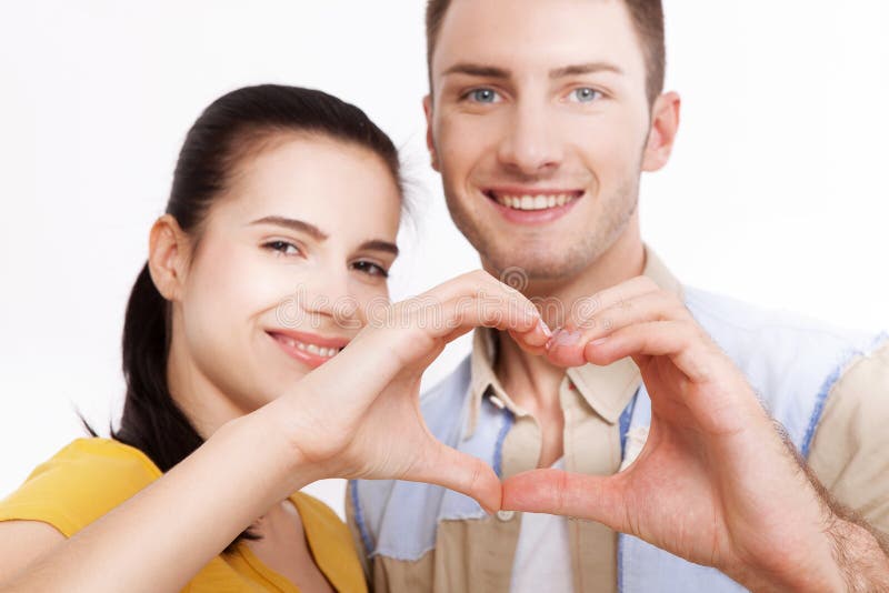 Closeup of couple making heart shape with hands isolated on white background stock photos Closeup of couple making heart shape with hands isolated on white background stock photos