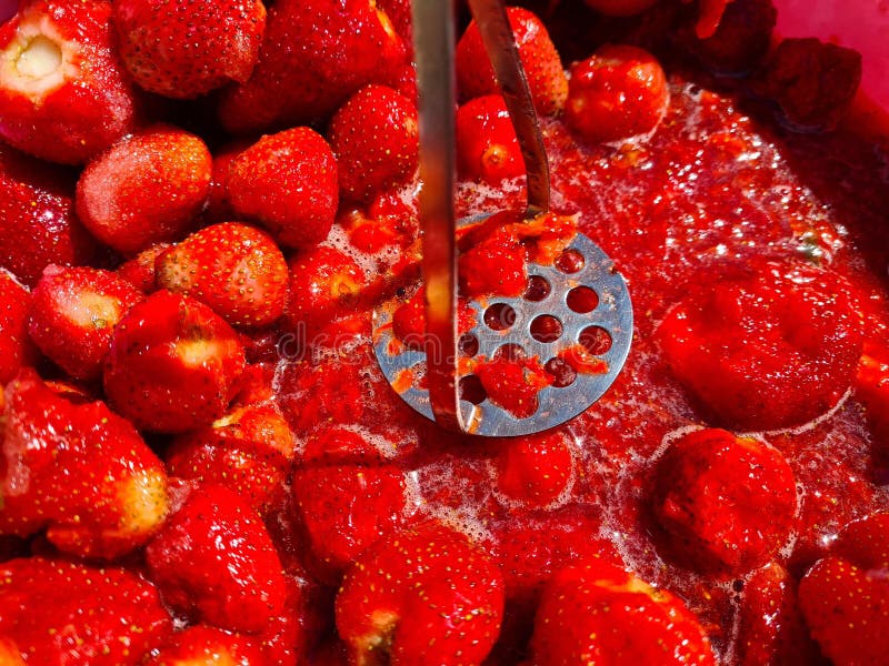 Closeup of Crushed Strawberries with Puree. Making Strawberry Jam Stock