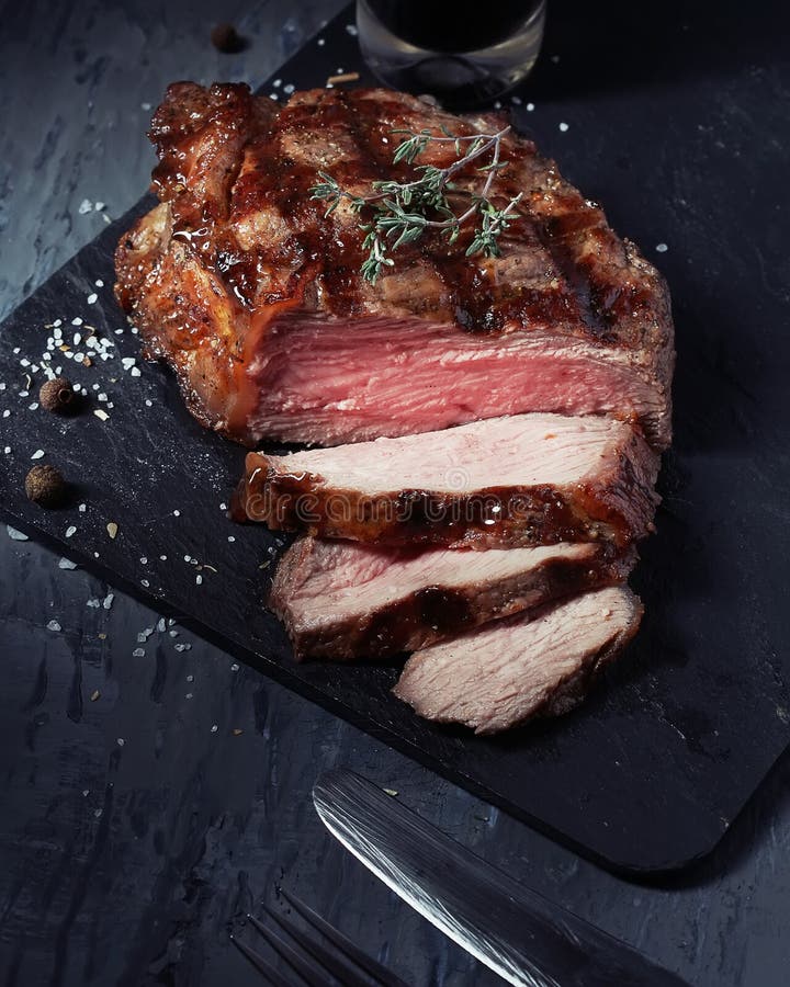 Closeup of Medium Rare Roast Beef Steak Stock Photo - Image of herb ...