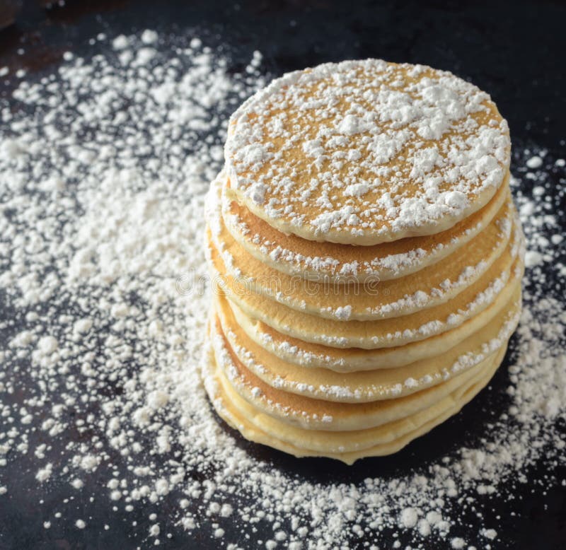 Stack of pancakes with powdered sugar