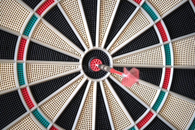Closeup of dart board with dart in the bulls eyes stock image Closeup of dart board with dart in the bulls eyes stock image