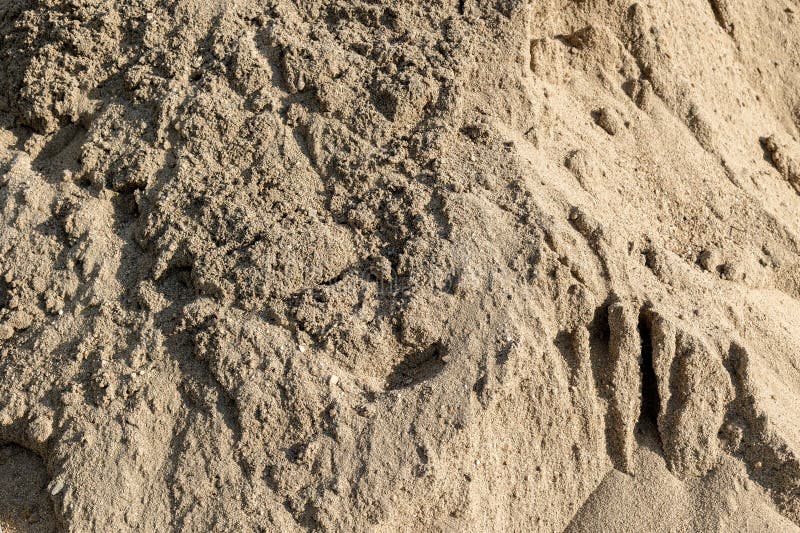 Closeup de sable texturé grossier avec motifs naturels et ombres images stock